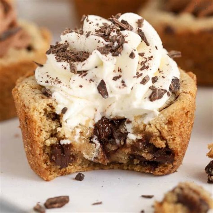 Chocolate chip cookie cup with a bite taken out of it.